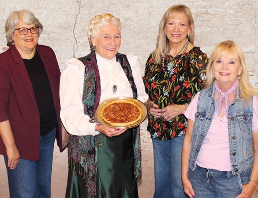 Lilac Festival and Boots on the Boulevard event organizers: Anita Miller Program Manager, Claremore Main Street; Susan Gebhart, Three-Twenty on Main Event Center; and Brenda Reno, Sailer Antiques & Collectibles with local celebrity Ollie Starr who will lead the Old Fashioned Pie Auction as &ldquo;Aunt Eller&rdquo; on May 22 at 6:45 pm. Value News VN Magazine and Values, Inc. photo, May 2026.
