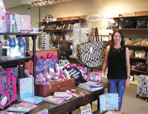 Owner Cari Bohannan beside the Lily Pulitzer collection at The District on Main.