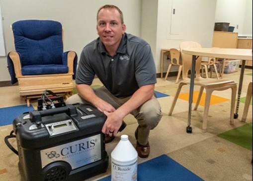 Chris Schultheis, M.S., Midwest Pathogend partner, demonstrates the CURIS fogging and newly invented spraying system in an early childhood education classroom at Lincoln Christian School, Tulsa, OK.