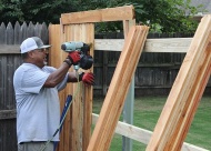 Employee Mike Acosta works on a fence near the 41st and Yale area.
