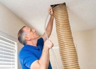 David Harris cleaning an air duct. Photo by TG Photography