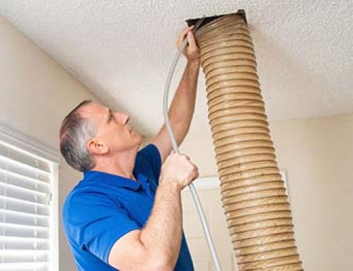 David Harris cleaning an air duct. Photo by TG Photography