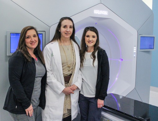 Dr. Terry Styles (center) and board-certified radiation therapists Robin Mixon (left) and Kacie Morris (right) with one of the clinic’s most effective pieces of equipment, the Varian Halcyon treatment system.