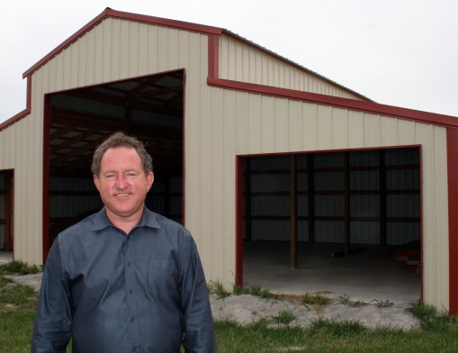 Carl Parson with a pole barn under construction by Inola Portable Buildings & Pole Barns.