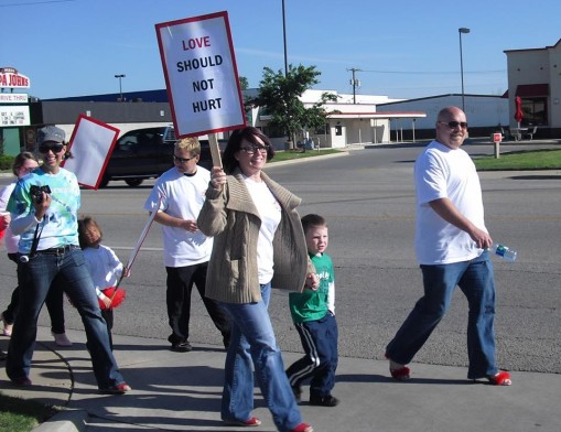 Participants in the Walk a Mile in Her Shoes are encouraged to make signs to raise awareness of domestic violence and sexual assault.