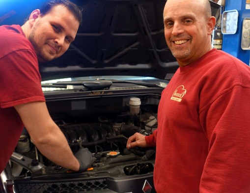 Owasso Auto Care Owner Tim Miller checks on progress of a job with Auto Specialist David Figart.  The shop provides services for virtually all vehicles including older cars and hot rods.