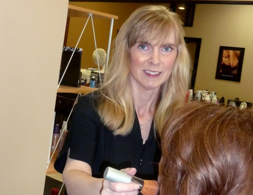 Nicole McGinnis, licensed aesthetician and owner of Reveal Salon & Aesthetics, applies custom blend mineral makeup to a client.