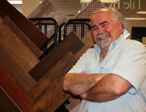 Tile by Tony owner Tony Sementi stands next to a showroom display featuring a few of his store’s new ceramic tile products in simulated wood patterns. 
Simulated wood designs are extremely popular in kitchen makeovers.