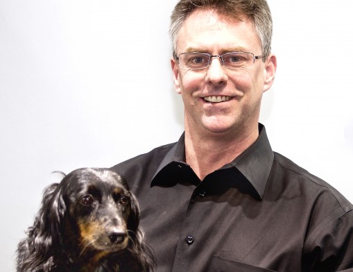 John E. Koller and store mascot Baxter greet customers with smiles at their Owasso jewelry store.