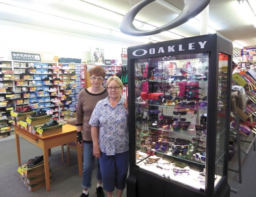 Store Manager Mary and Sales Associate Nancy with Felts Shoes’ large selection of 
Oakley sunglasses.