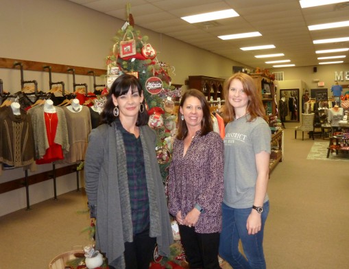 Nikki Hall, Cari Bohannan, and Kayla Dossett welcome holiday shoppers to The District on Main in downtown Claremore.