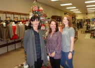 Nikki Hall, Cari Bohannan, and Kayla Dossett welcome holiday shoppers to The District on Main in downtown Claremore.
