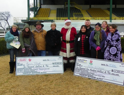 Santa hands out the cash prizes from 2016’s Santa Cash Shop Local event.