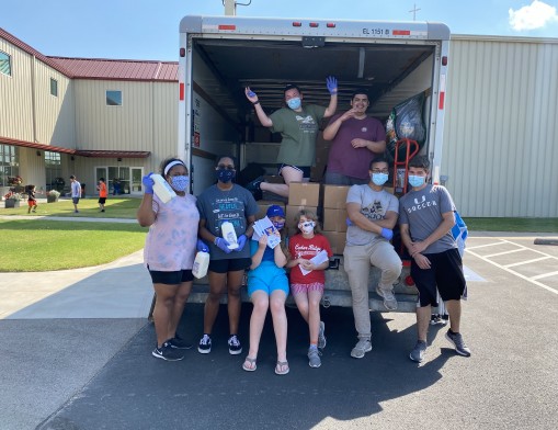 The youth volunteers’ desire to serve those in need is unrelenting, through May, through June, now July and through rainstorms and near 100-degree heat. The Abiding Harvest Youth Grocery Giveaway each Wednesday has a line of waiting cars winding through the parking lot and out into the street.