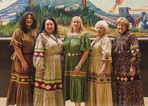 Pictured with the mural depicting Will Roger’s iconic life are Indian Women’s Pocahontas Club officers and members (left to right) Mikela Campos, Debra West, Linda Coleman, Celeste Tillery, and Monte Ewing. Photo by TG Photography