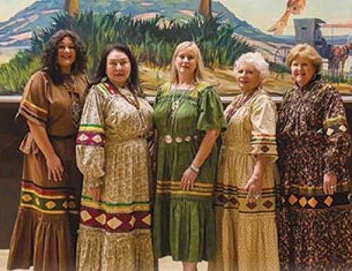 Pictured with the mural depicting Will Roger’s iconic life are Indian Women’s Pocahontas Club officers and members (left to right) Mikela Campos, Debra West, Linda Coleman, Celeste Tillery, and Monte Ewing. Photo by TG Photography