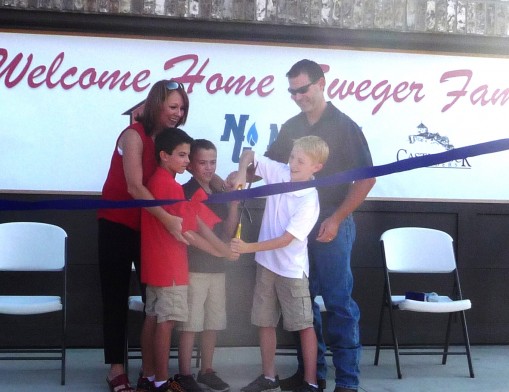 Retired U.S. Army Staff Sgt. Ronny Sweger, his wife, Claudia, and their triplet sons, Brooks, Brett and Briggs, cut the ribbon at their new mortgage-free home provided through Operation FINALLY HOME, Castlerock Builders and New Gulf Resources, LLC.