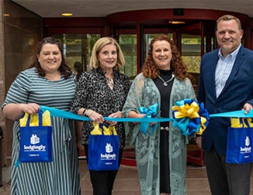 Hospitality House of Tulsa board members and staff celebrate the growth and expansion of Lodgingly, a program offering discounted hotel rooms for patients traveling for medical care. From left: Elise Gaulin, Guest Experience Director; Terri Ramseyer, Advisory Board Member; Toni Moore, President and CEO; and Wes Pebsworth, Board Trustee. Photo courtesy of Hospitality House of Tulsa.