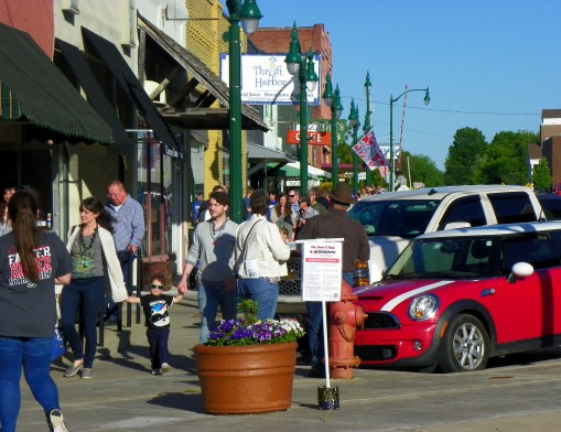 Guests stroll along the street in downtown Claremore visiting various businesses, tasting samples from local restaurants, enjoying live entertainment and gazing at the children’s flag art at last year during Sip, Savor & Shop: Taste of Claremore.