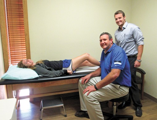 Sequoyah High School soccer player Megan Oldashi is examined by Dr. Steven Hardage (seated), as Physician Assistant Isaac Bethea watches. Claremore’s Eastern Oklahoma Orthopedic Center is once again offering Saturday morning sports injury clinics to see patients who have been injured in Friday night play.