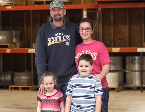 Ed and Leanna Yoder with their children are pictured inside their expansive materials warehouse.