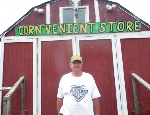 Farmer Jack stands in front of the “Corn”venient Store.