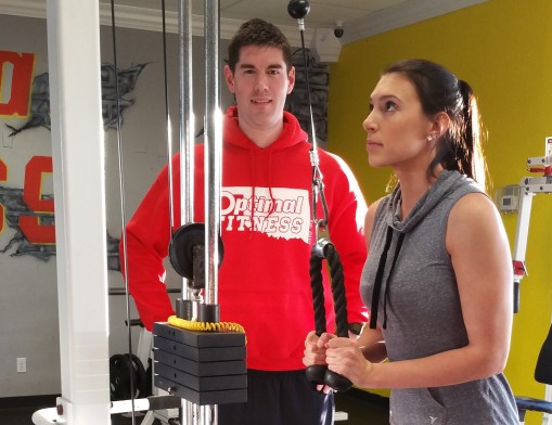 Personal trainer Taylor Miller trains Stephanie Hubele 
at Optimal Fitness.