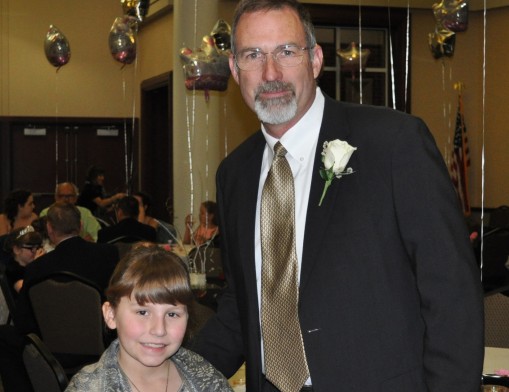 Makayla at last year’s Me and My Guy Dance with her 
grandfather (“Poppie”) Jeff Ault. Makayla attended with her 
Poppie since her dad was serving overseas in the Marine Corps.