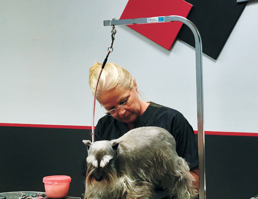 Kelly McKinney treats a happy customer to to a nail trim.