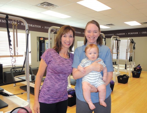 Teresa McIlroy, owner of Strength of Mind & Body, with client Beth West and her son, Abraham.