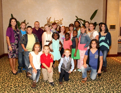 LeAnne Taylor, emcee of the Style Show, with children/models from the Baptist Children’s Home, Owasso.