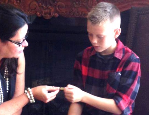 Melanie Hasty-Grant hands a Character Coin to a student who has exhibited an act of character.