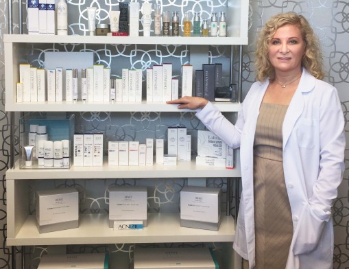 Olga Arnold displays some of the many great skin care product lines at Skin Ambitions Medical Spa.