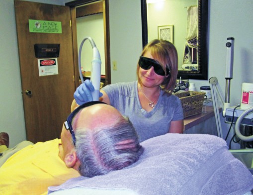 Candi Budde, laser technician, performs a procedure on a patient at A New Image Cosmetic Laser Center in Claremore.
