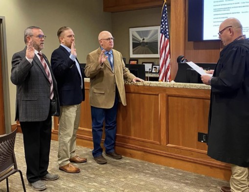Commissioner Dan DeLozier of District 1, Commissioner Ron Burrows of District 3, and County Assessor Scott Marsh took oath - administered by Judge Stephen Pazzo - to faithfully execute duties of their respective offiice.