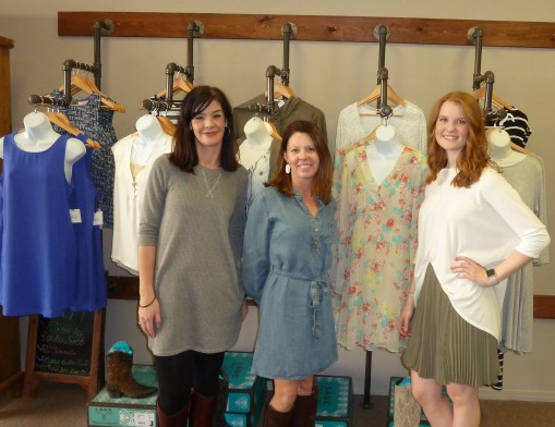 (L to R): Nikki Hall, store owner Cari Bohannan, and Kayla Dossett with a few of the spring selections at The District on Main.