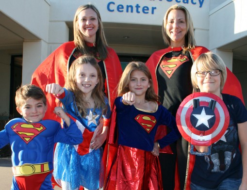 Co-Chairs Ashley Neal and Mary Ann Cameron get in the spirit for the 3rd annual CAN Superhero Challenge scheduled for April 3, 2016. Their Super Kids are (L to R): Max Neal, Lizzie Cameron, Taylor Neal and Michael Cameron.