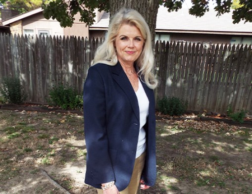 Kim Koleber stands in the backyard of her event center, where she has been advocating during the pandemic.