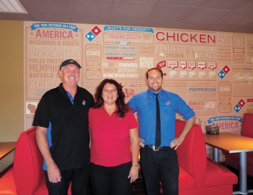 Dale and Rosie Wills, Domino’s franchise owners, with their son and store manager Josh.