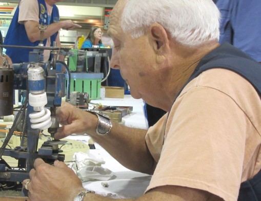 Tulsa Rock and Mineral Show 2016 Chairman Finis Riggs shows careful skill and technique in working with minerals.