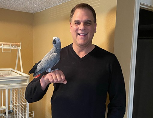 Jeff Wetterman with his Congo African Grey Parrot, Gracie.