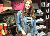 Sales Associate Kayla Dossett displays the latest bags from John Hart.