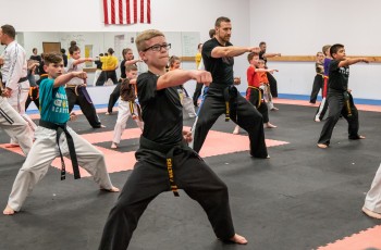 Students of all ages and skill levels begin class with a warmup.