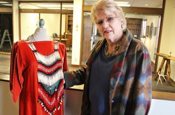 Betsy Swimmer appreciates an authentic Native American dress, made by one of the artists whose work will be on display at the Vault Gallery in Catoosa.