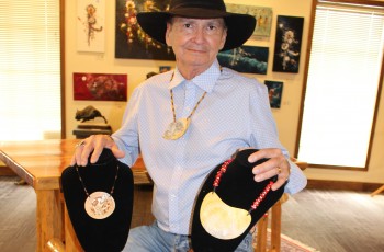 Harry Beaver, Muscogee artist & shell carver
displays some of his carved shell jewelry.