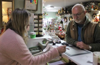 Claremore resident Terry Culp inquires from Dorothy’s Flowers owner Holly Thompson about a purchase.