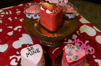 These precious Valentine’s cakes and cupcakes are available for order and make great gifts, with optional décor and flavor choices.  Heart-shaped cupcakes are individually packaged in the heart-shaped tin for $2 each.