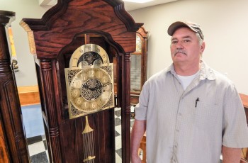 Student Leslie Weeks repaired this grandfather clock brought to Clock Store owner Jonathan Schultz. Weeks, who is legally blind, is learning the craft of repairing clocks of all sizes from teacher and shop owner Schultz.