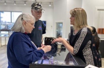 Sales Associate Debbie Keener assists a couple looking for just the right ring.