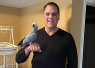 Jeff Wetterman with his Congo African Grey Parrot, Gracie.